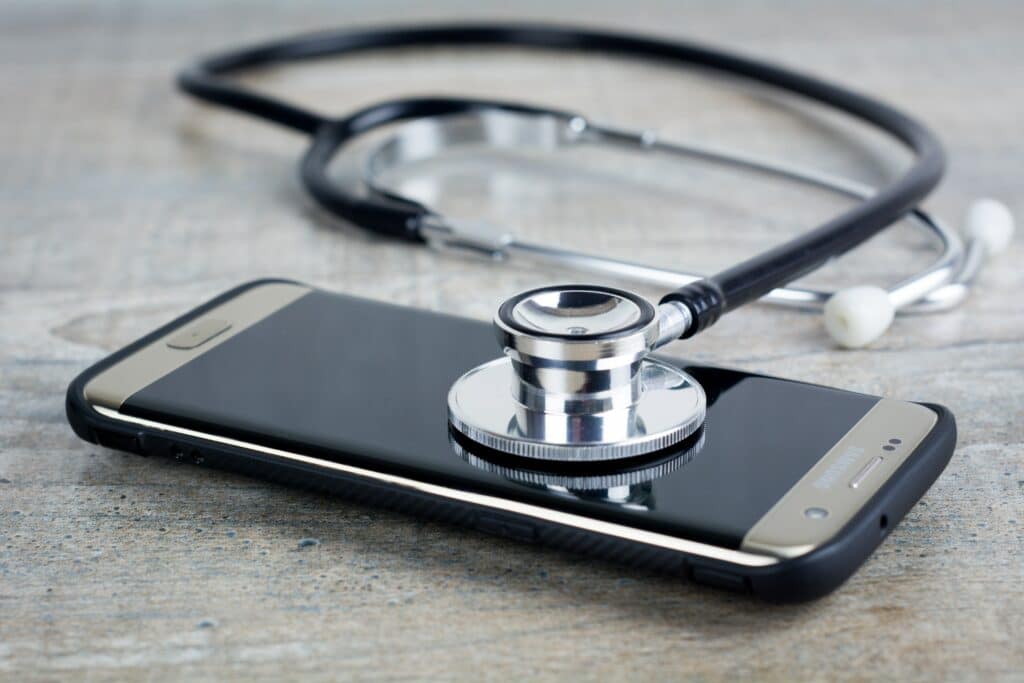 Picture of a stethoscope "diagnosing" a phone.